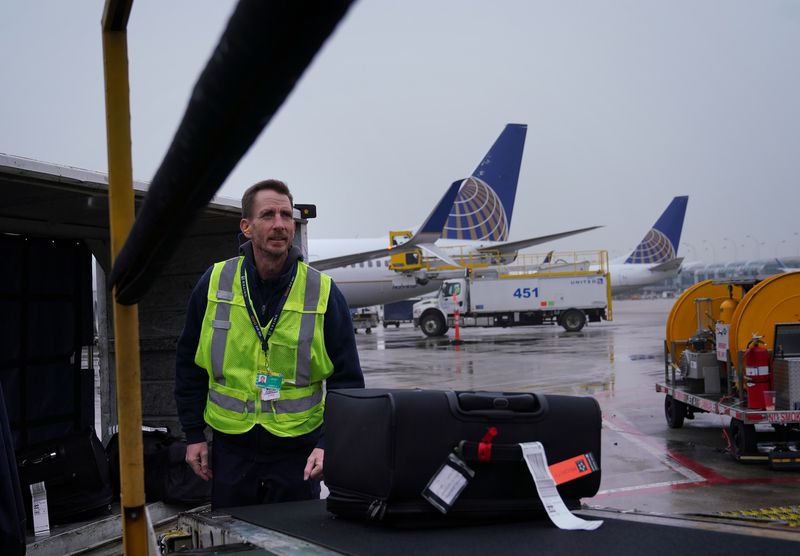United baggage handler and in-house photographer Joe Lammerman works on the ramp at O'Hare International Airport on Jan. 15, 2020, in Chicago. (E. Jason Wambsgans / Chicago Tribune)