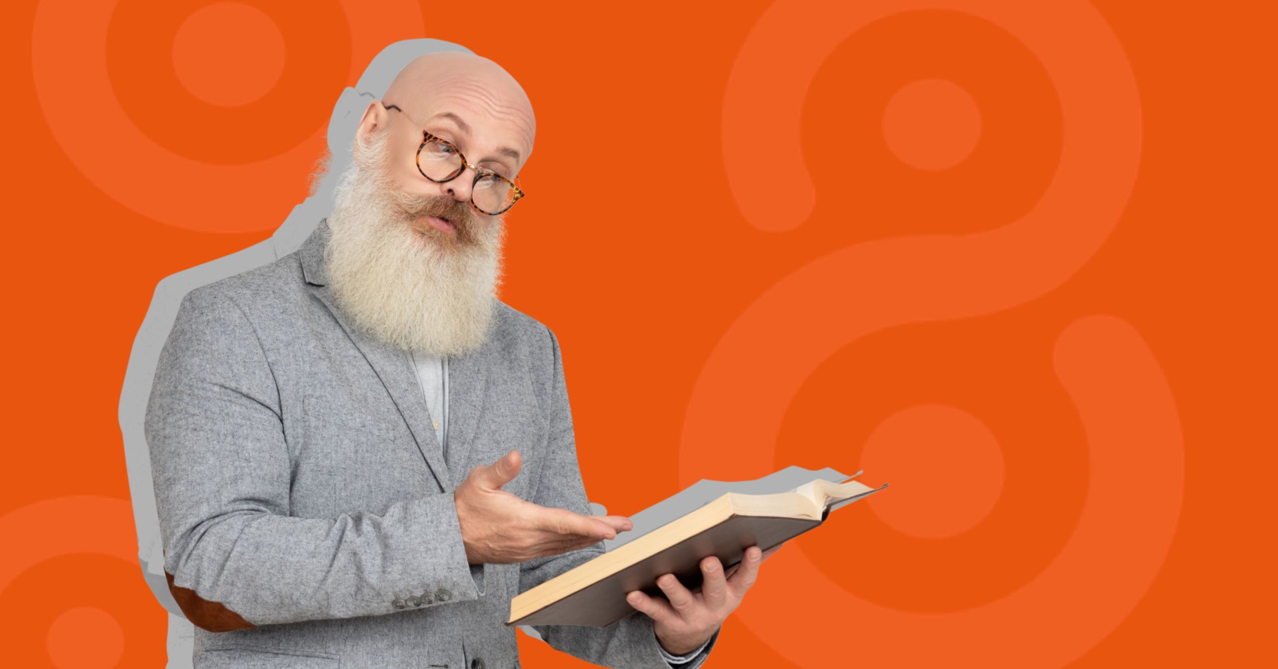Smart man with beard and glasses looking at book