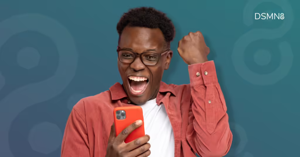 man celebrating success looking at his phone