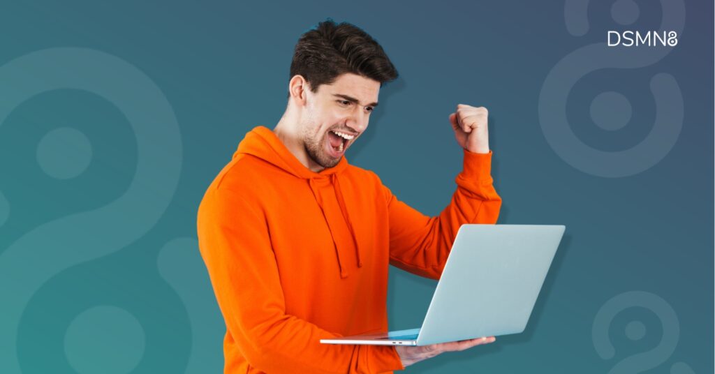 salesperson celebrating success holding laptop