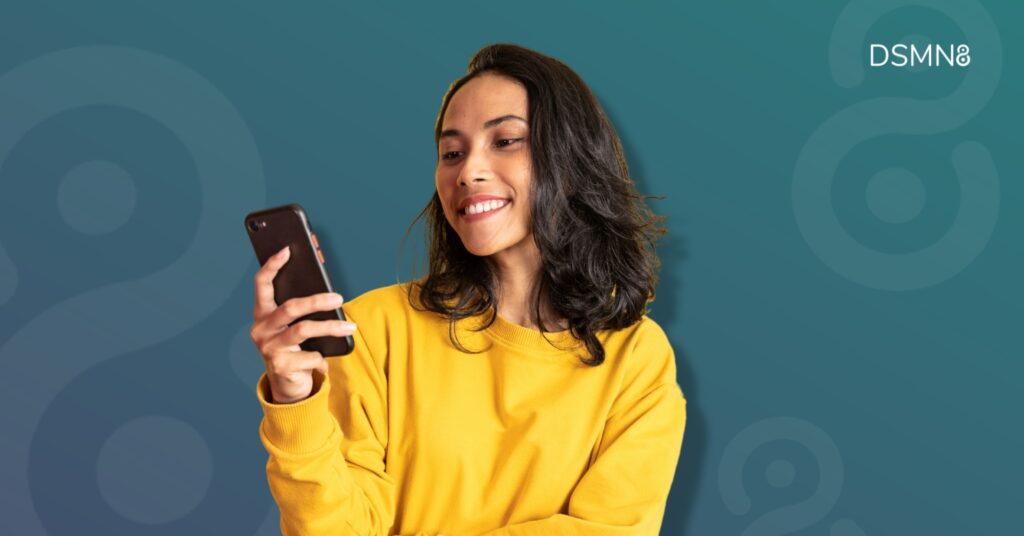 smiling woman looking at cellphone