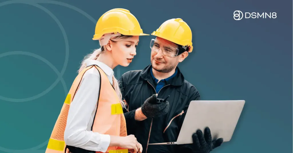 logistics employees looking at laptop