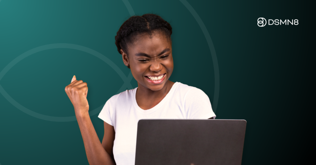 woman holding laptop celebrating success